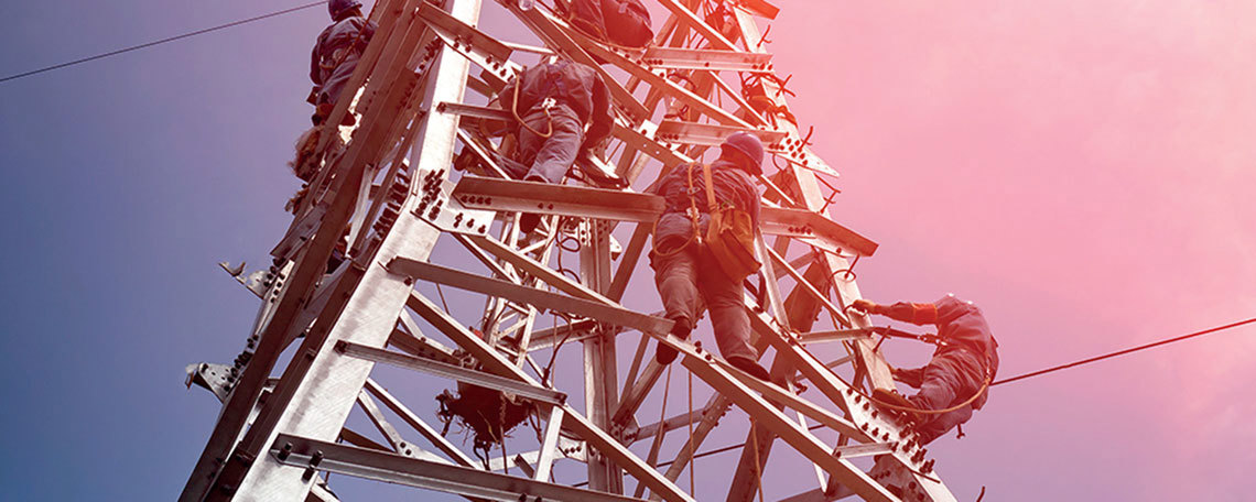 Men climbing power pole