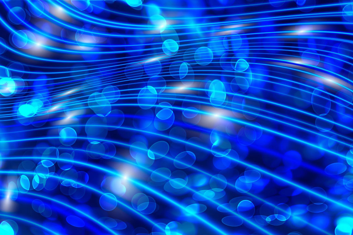 Abstract blue lights shimmer against a black background, creating a dynamic and visually striking composition.