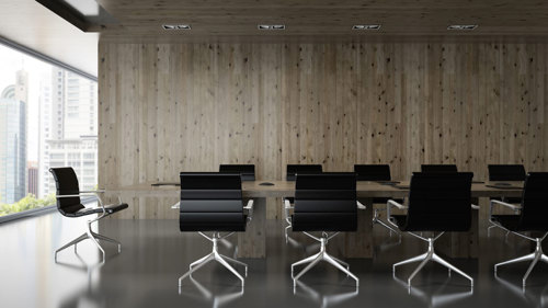A conference room featuring a large table surrounded by several chairs, designed for meetings and discussions.